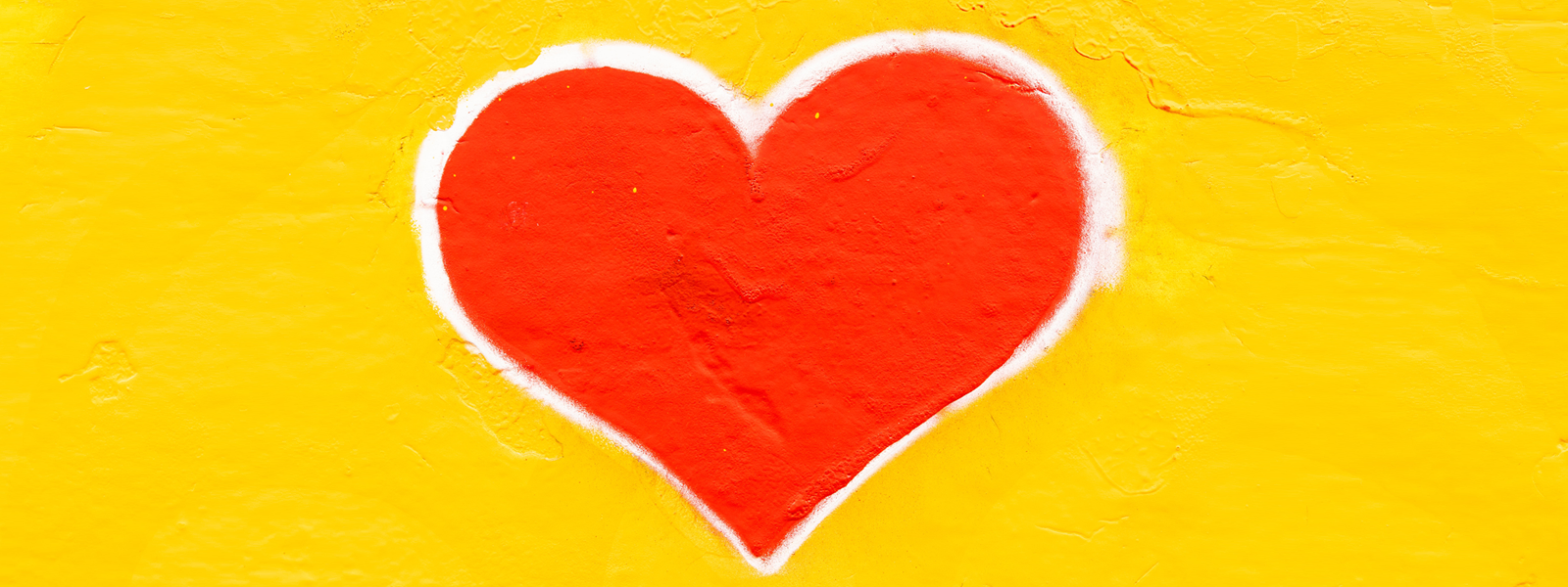Red heart on yellow background. 