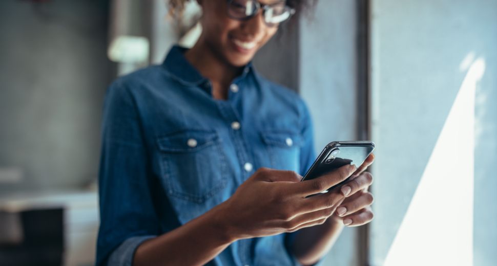 Woman in blue looking at cellphone