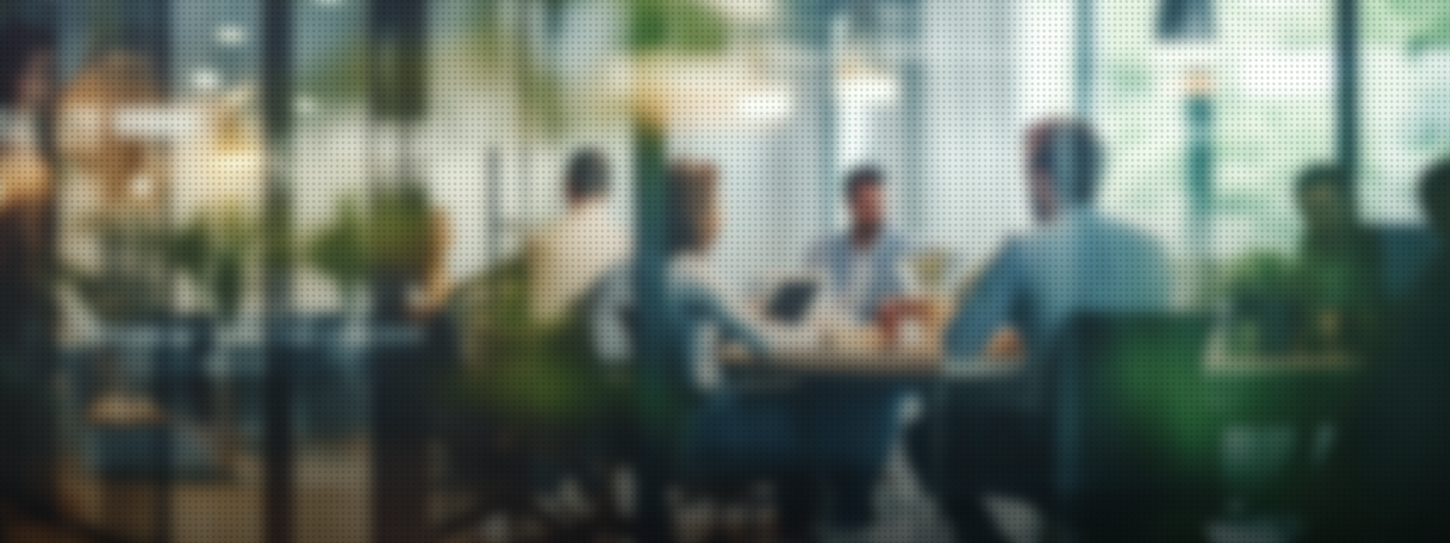 blurry picture of group of coworkers sitting around a table working