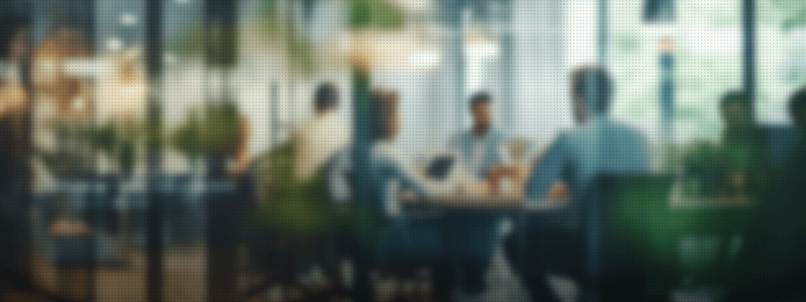 blurry picture of group of coworkers sitting around a table working