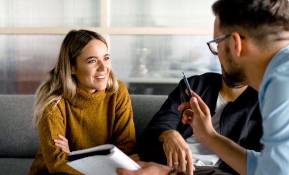 A couple talking to a real estate agent about Real Estate Advertising with Lone Wolf Boost