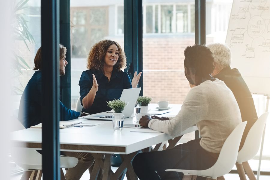 Group of coworkers sitting at a meeting room table